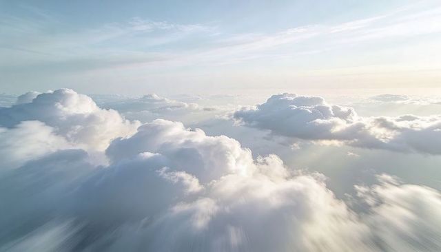 Sunlit Cumulus Clouds Drifting Over Pastel Horizon — Expansive Aerial Cloudscape