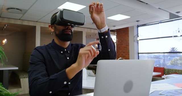 Young professional using virtual reality headset in modern office workspace - Download Free Stock Images Pikwizard.com