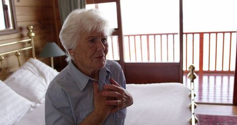 Senior Woman Experiencing Chest Pain at Home