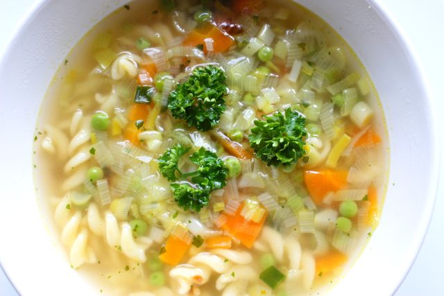 Perfect for food blogs, healthy eating promotions, and recipe websites. This image showcases a visually appealing, hearty vegetable noodle soup with fresh ingredients, great for illustrating home-cooked meals.