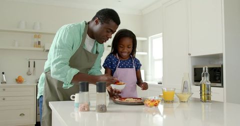 Family Bonding - Father and Daughter Cooking Together in Modern Kitchen