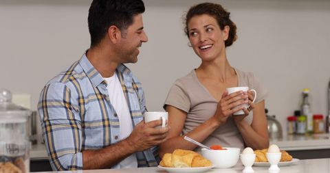 Couple Enjoying Breakfast Together in Kitchen