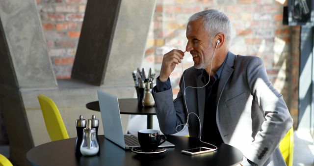 Confident Mature Professional Having Video Call in Modern Cafe - Download Free Stock Images Pikwizard.com