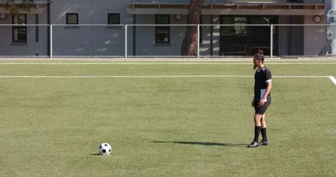 Teen Soccer Player Contemplating Strategy on Field