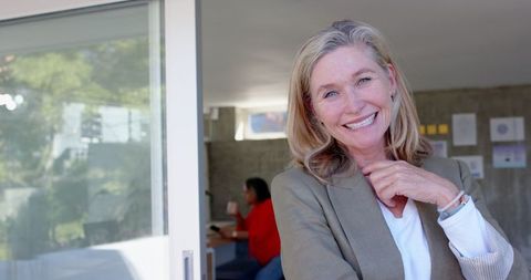 Senior Woman Leader Smiling in Modern Office Environment