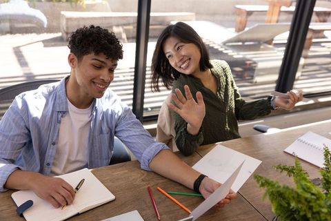 Diverse Coworkers Reviewing Documents in Bright Office