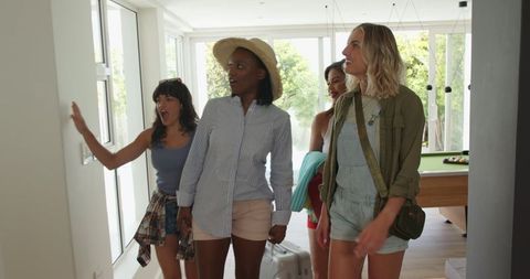 Excited women arriving at holiday home exploring