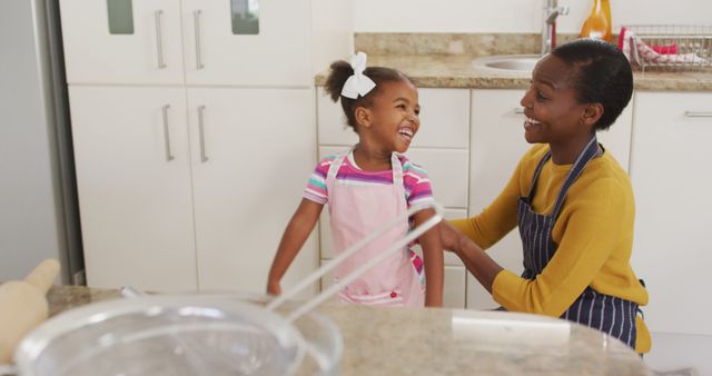 Smiling African American Mother and Daughter Baking in Kitchen - Download Free Stock Images Pikwizard.com