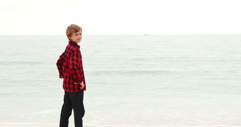 Happy Boy in Red Checked Shirt by the Seaside