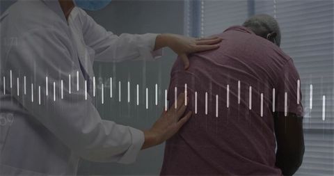 Healthcare professional diagnosing patient back pain in clinic