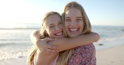 Joyful Friendship Embrace Smiling by Sunny Seashore - Download Free Stock Images Pikwizard.com