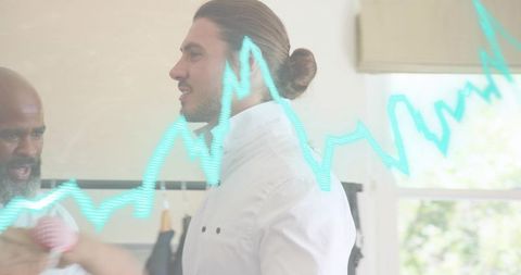 Menswear styling session model wearing white shirt and man bun, stylist adjusting fit