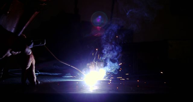 Industrial Welder Working in Dark Workshop Creating Bright Sparks - Download Free Stock Images Pikwizard.com