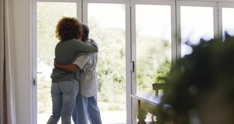 Couple Embracing Peacefully by Sunny Window in Cozy Home