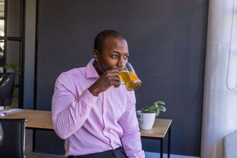 Businessman Enjoying Beer Break in Modern Office Lounge