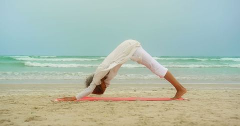 Senior Woman Practicing Downward Dog Yoga Pose on Beach - Download Free Stock Images Pikwizard.com