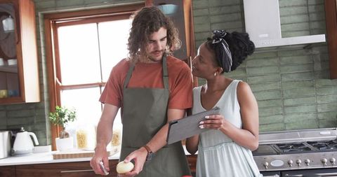 Diverse Couple Cooking Together in Modern Home Kitchen