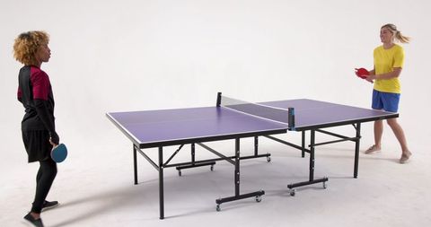 Diverse Female Athletes Enjoy Table Tennis in Studio