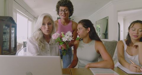 Diverse women collaborating on wedding planning at home