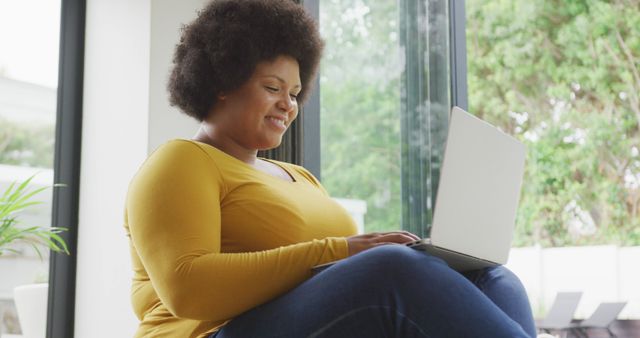 Smiling Woman Using Laptop at Home by Window - Download Free Stock Images Pikwizard.com