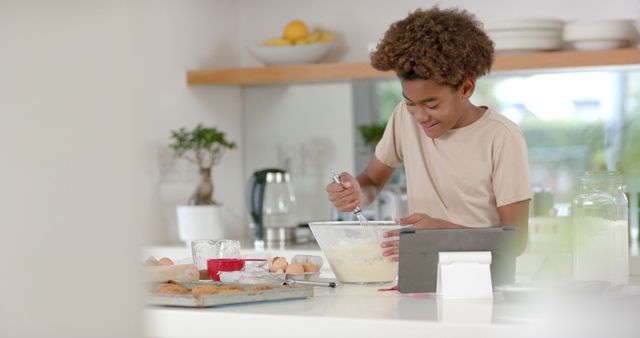 Young Boy Baking Cake and Watching Recipe on Tablet in Modern Kitchen - Download Free Stock Images Pikwizard.com