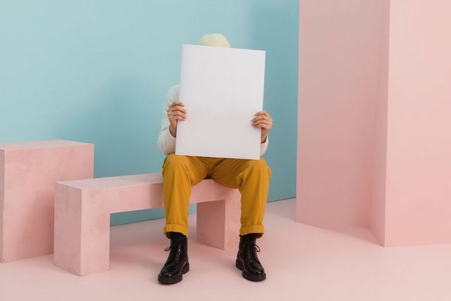Model in pastel studio with white board and minimalist fashion