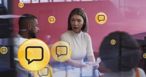 Business meeting with animated communication icons overlay