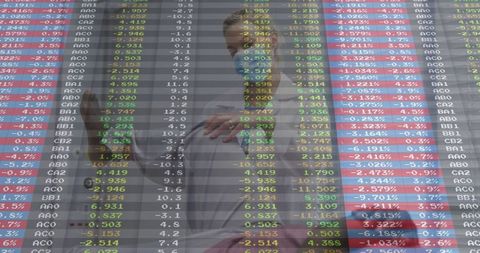 Finance professionals analyzing digital stock data in modern office