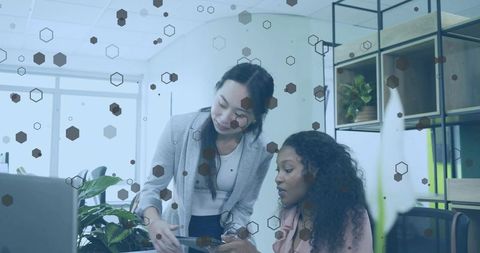Businesswomen Collaborating in Modern Office Workspace