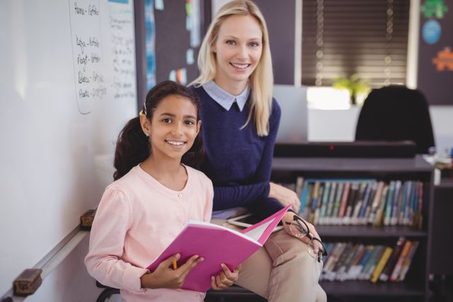 Teacher and schoolgirl smiling in classroom, ideal for educational content, school promotions, and academic materials. Highlights positive teacher-student interaction and learning environment.