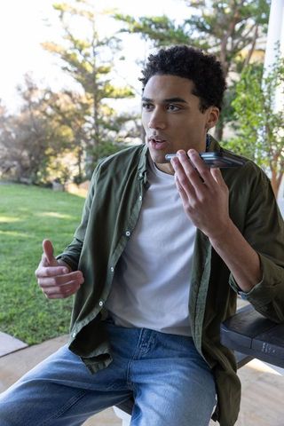 Man on Patio Engaging in Hands-Free Phone Call