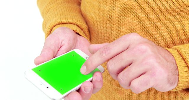 Person using smartphone with green screen in sweater - Download Free Stock Images Pikwizard.com