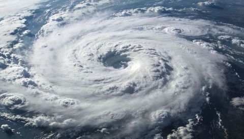 Rotating hurricane eye over ocean from spaceborne satellite view with spiral rainbands