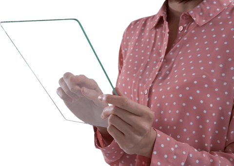 Woman's hands operating transparent glass tablet in polka dot shirt