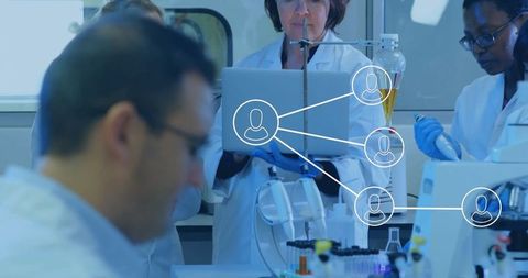 Female Scientists Collaborating with Technology in Modern Laboratory