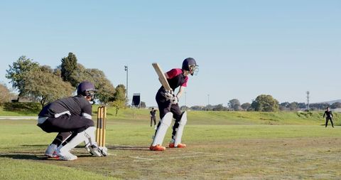 Batsman and Wicketkeeper Engaged in Dynamic Cricket Match