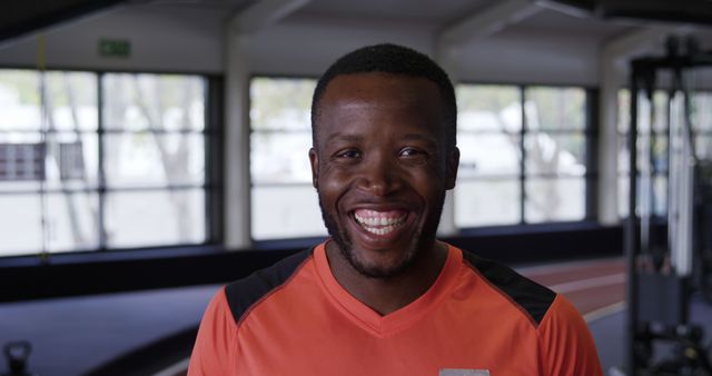 Happy african american athlete smiling in indoor gym facility - Download Free Stock Images Pikwizard.com