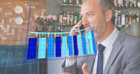 Businessman analyzing profits with rising chart on smartphone at bar