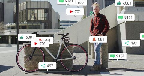 Standing cyclist leaning on bollard next to bicycle with social media notification bubbles