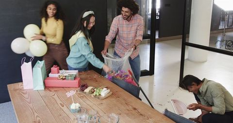 Colleagues Cleaning After Baby Shower in Office Celebration
