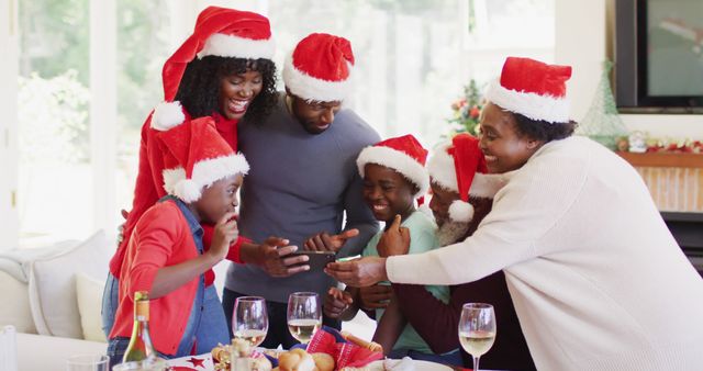 Happy Family Wearing Santa Hats Celebrating Christmas Together - Download Free Stock Images Pikwizard.com