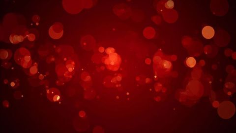 Glowing crimson bokeh background with floating orbs and sparkling particle lights backdrop