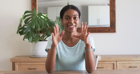Friendly Woman Engaging in Virtual Meeting at Home