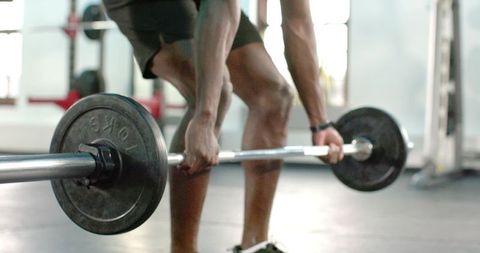 African American Man Deadlifting Heavy Barbell Showing Strength Focus Athletic Training