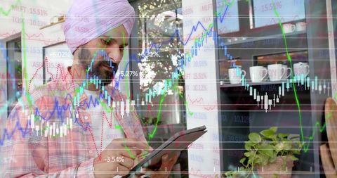Indian investor tapping tablet stylus overlaid with stock charts and candlestick graphs
