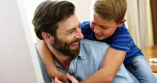 Happy father and son playing at home, bonding and smiling - Download Free Stock Images Pikwizard.com