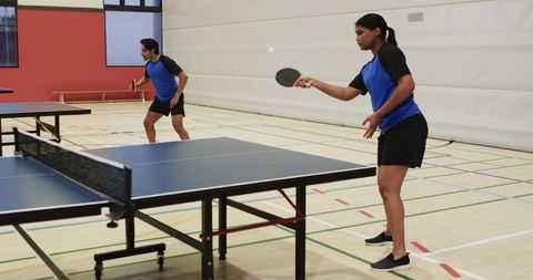Players competing in energetic table tennis match