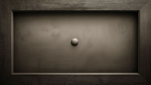 Minimalist recessed cabinet panel featuring single round knob and textured wood frame