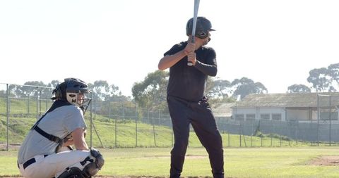 Diverse Male Batter and Catcher Preparing at Home Plate on Sunny Baseball Field