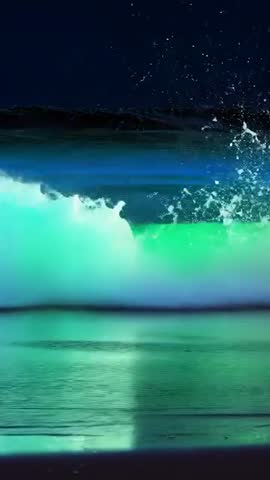 Neon Ocean Wave Curling and Glowing Surf Breaking | Vertical Video of Luminous Swell